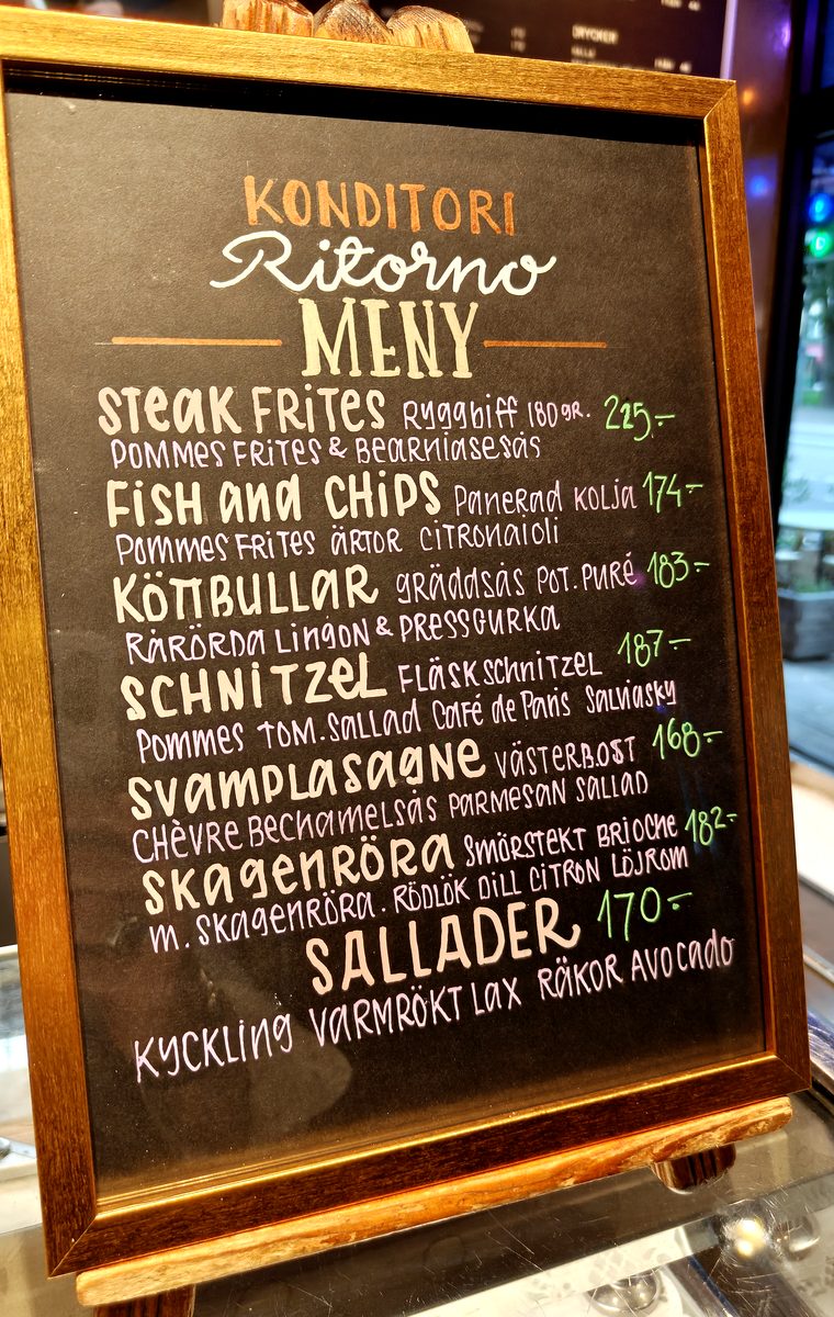 Framed hand-lettered Ritorno restaurant menu inside a cafe