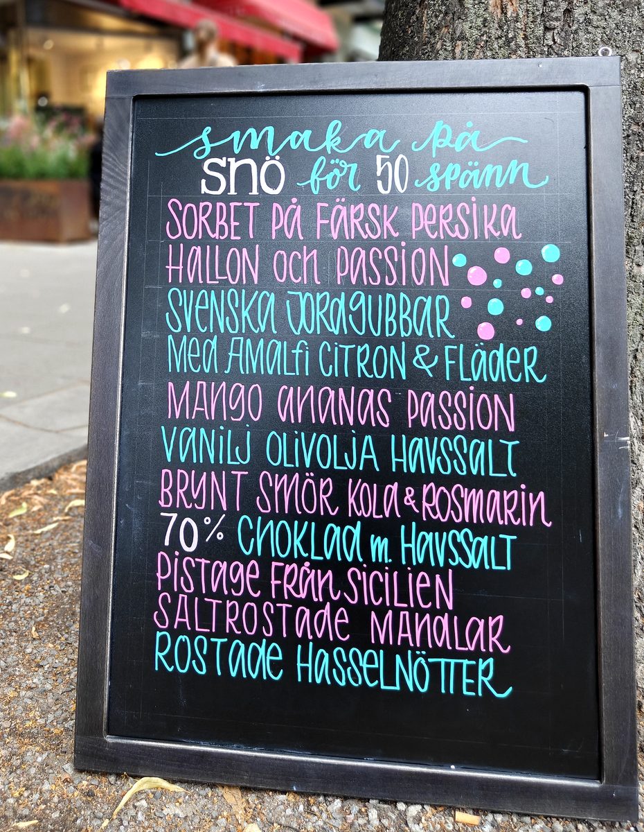 Hand-lettered sidewalk sign with sorbet flavors